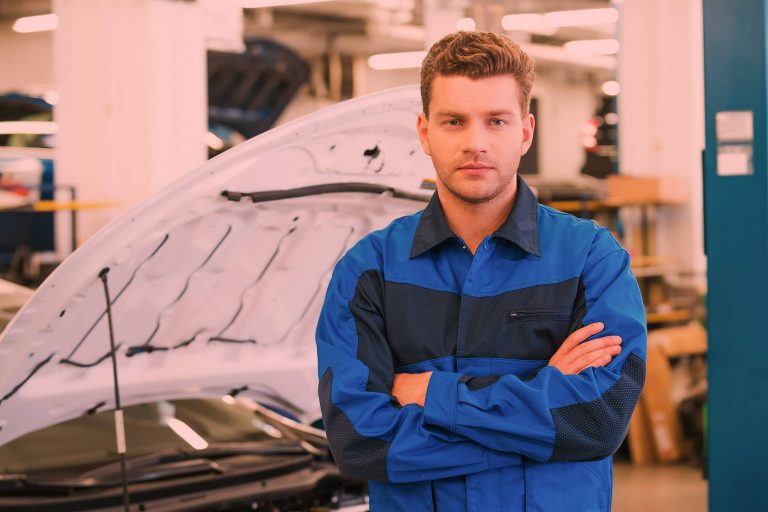 auto electrician wearing blue jacket