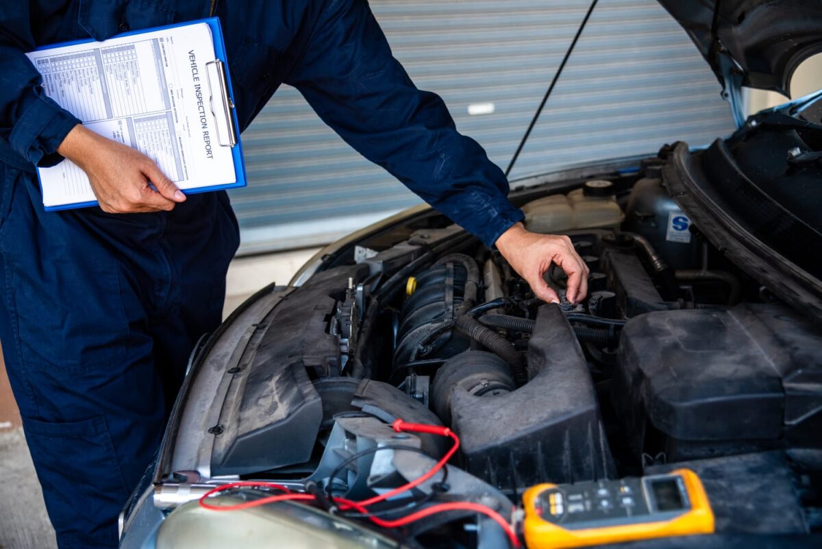 Mechanic inspecting a car engine during an electrical diagnostic