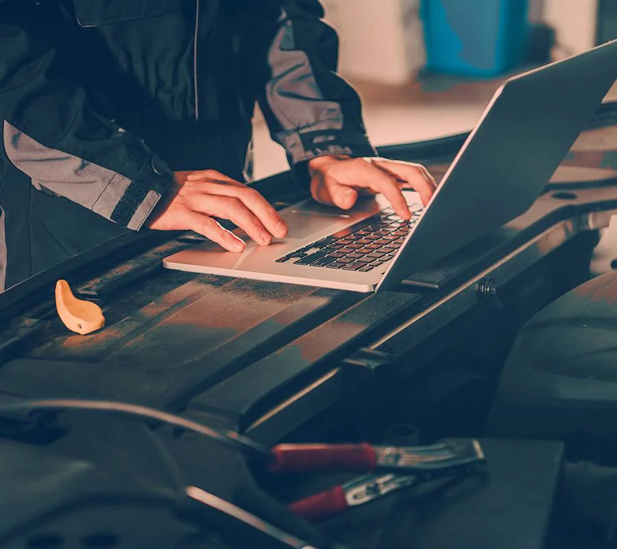 Diagnostic scan tool plugged into a car to read fault codes