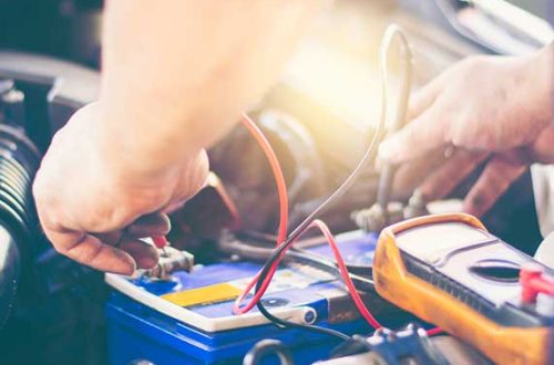 about-battery man checking car battery